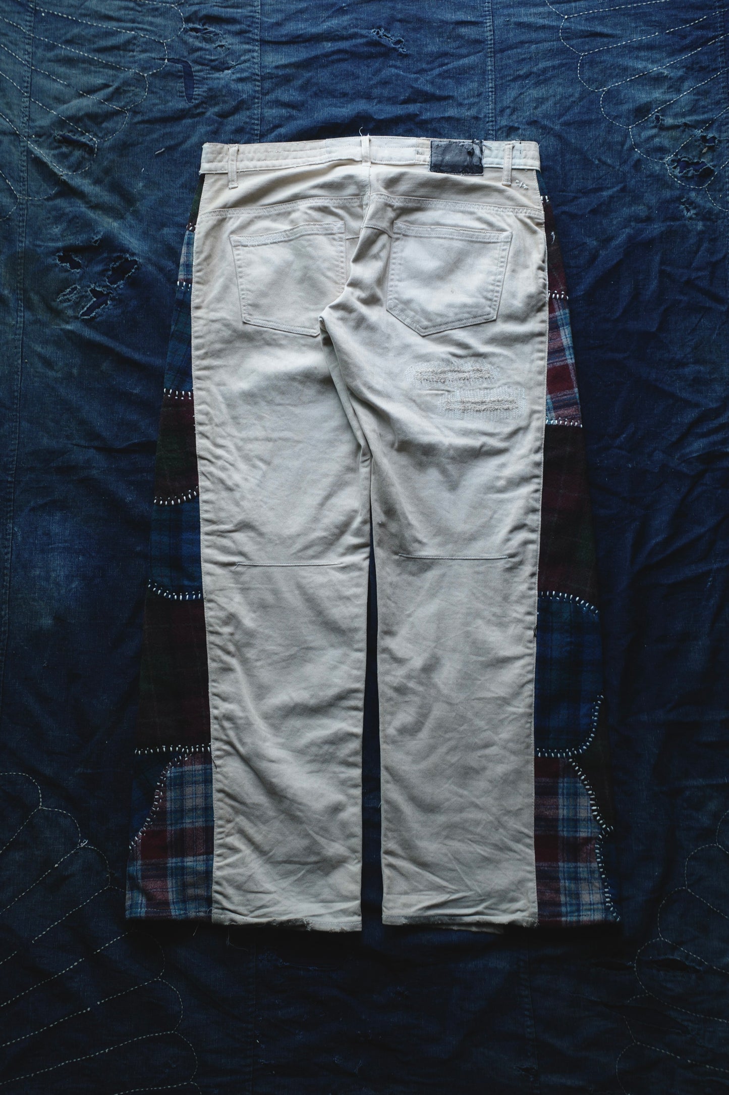 Reconstructed Number Nine tea-dyed denim jeans w/ patchwork plaid side-panel