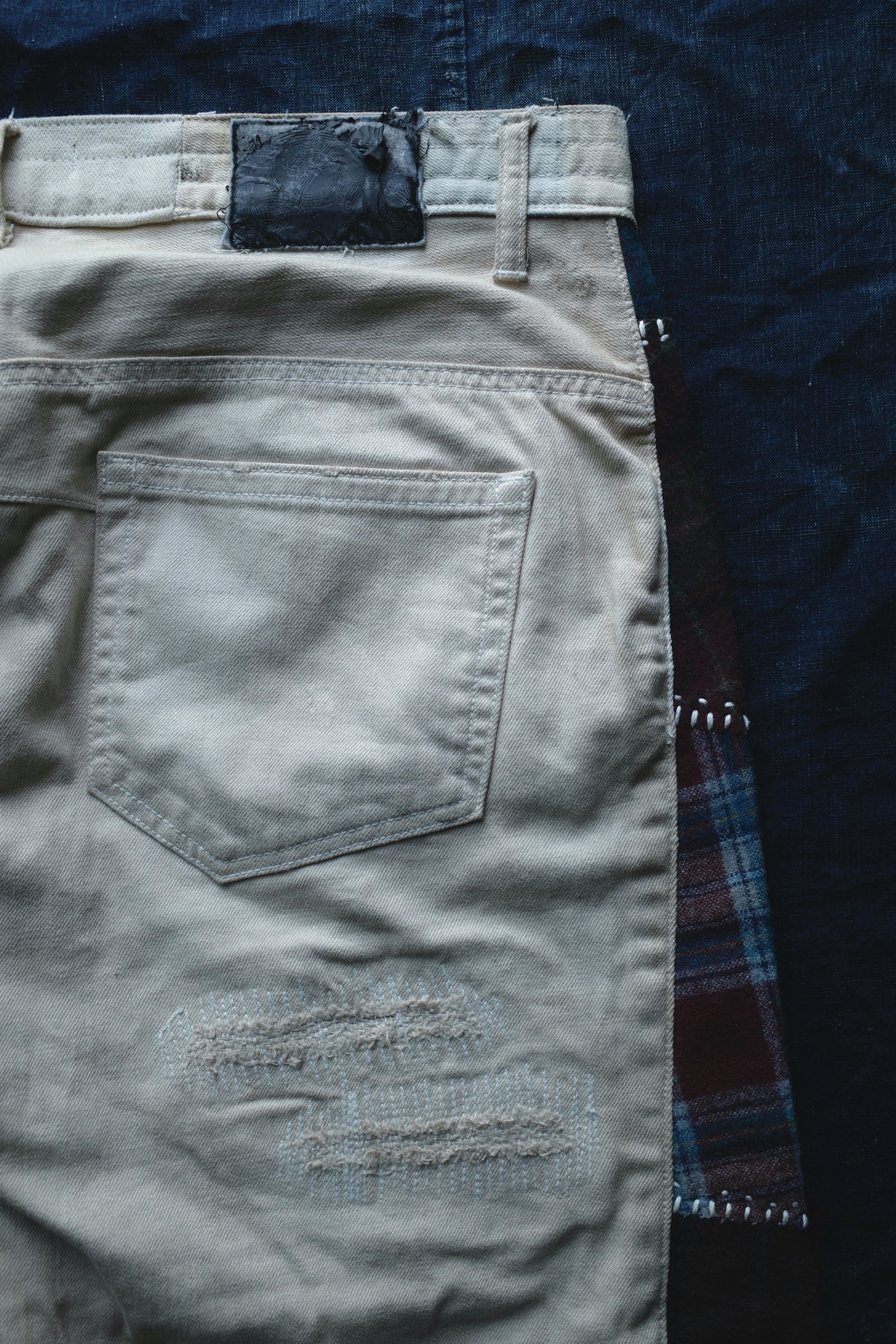 Reconstructed Number Nine tea-dyed denim jeans w/ patchwork plaid side-panel