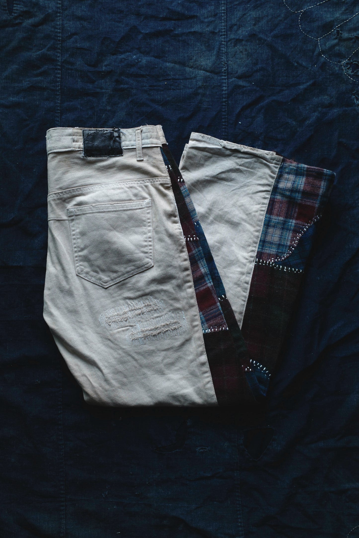 Reconstructed Number Nine tea-dyed denim jeans w/ patchwork plaid side-panel